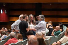 Julio Castaños Soler and his wife Mariana Molina speaking with Manuel Caceres in the audience