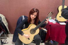 Edith Pageaud testing a guitar