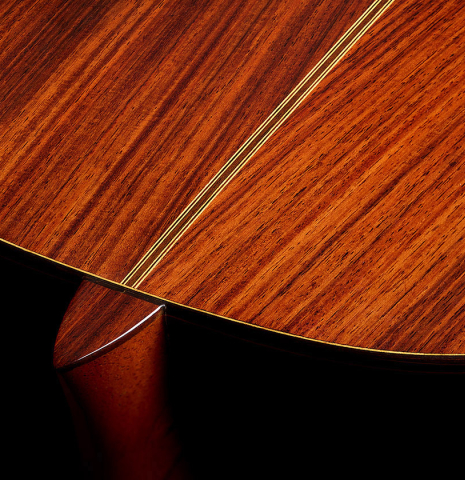 The heel, back binding and purfling of a 1996 Sergio Abreu classical guitar made of spruce and Indian rosewood