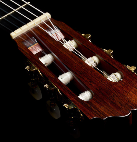 The headstock veneer and tuning machines of a 1996 Sergio Abreu classical guitar made of spruce and Indian rosewood