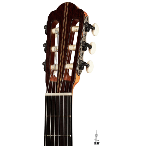 The headstock of a 2023 Manuel Adalid "Hauser" classical guitar made of spruce and Indian rosewood on a white background