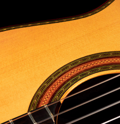 The soundboard and rosette of a 2015 Manuel Adalid "Torres" classical guitar made of spruce and Indian rosewood