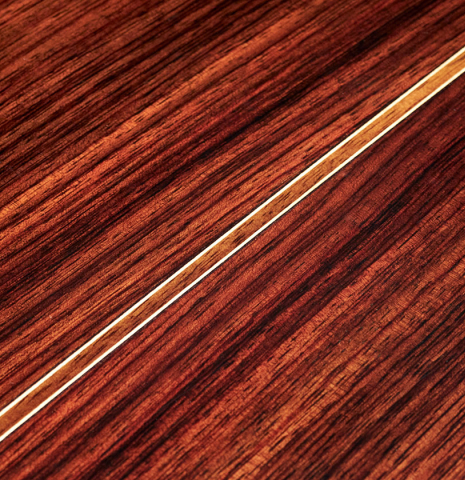 A detailed close-up of the back and center seam of a 2021 Manuel Adalid &quot;Torres&quot; classical guitar made of spruce and Indian rosewood