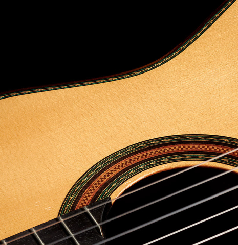 The soundboard and rosette of a 2021 Manuel Adalid &quot;Torres&quot; classical guitar made of spruce and Indian rosewood