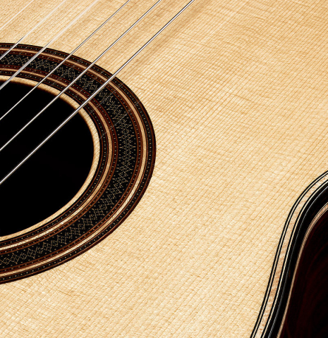 The soundboard and rosette of a 2023 Colin van Aelbrouck classical guitar made of spruce and Indian rosewood