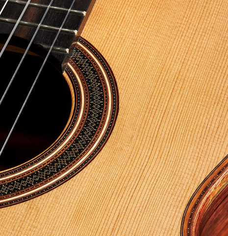 Detail of the top and rosette of a 2024 Colin van Aelbrouck classical guitar made of cedar and Indian rosewood