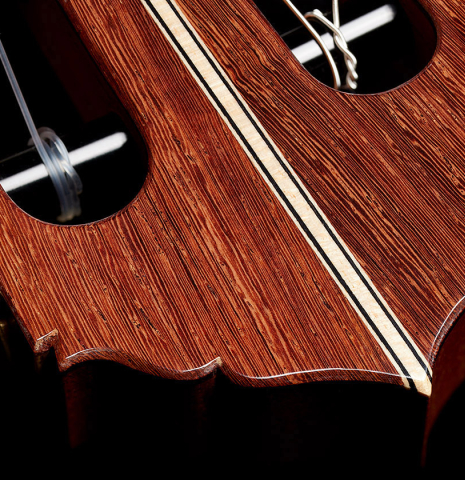 The headstock veneer of a 2025 Colin van Aelbrouck classical guitar made of spruce and African rosewood