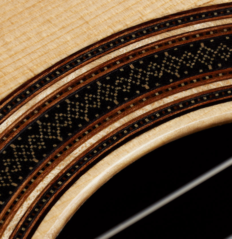 Close-up detail of the rosette of a 2025 Colin van Aelbrouck classical guitar made of spruce and African rosewood