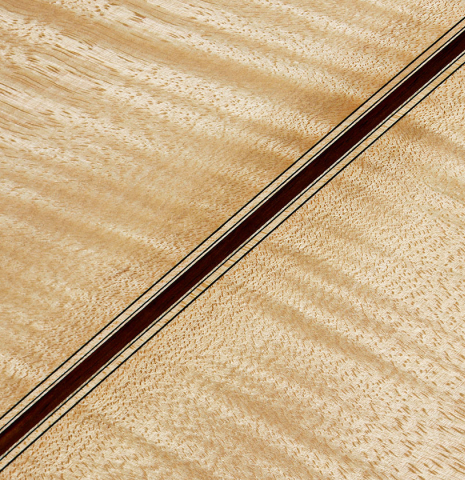 The back center seam of a 2025 Colin van Aelbrouck "Rodriguez" classical guitar made of spruce and maple