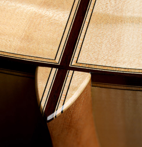 The heel, back binding and purfling of a 2025 Colin van Aelbrouck "Rodriguez" classical guitar made of spruce and maple