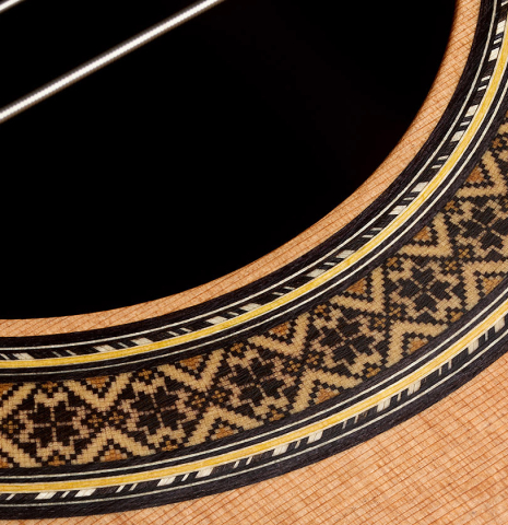 The soundboard and rosette detail of a 2021 Alhambra “Mengual y Margarit NT” classical guitar made of cedar and Indian rosewood