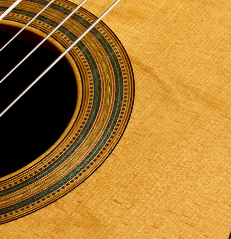 The top and rosette detail of a 2000 Simon Ambridge classical guitar made with spruce and Indian rosewood