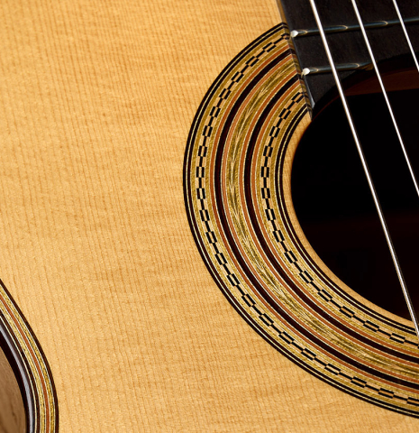 The soundboard and rosette of a 2008 Simon Ambridge "1887 Torres SE 111" classical guitar made of spruce and maple