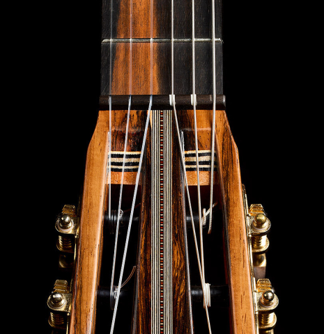 The headstock veneer of a 2025 Ariel Ameijenda "70th Anniversary" classical guitar made of Alerce and CSA rosewood