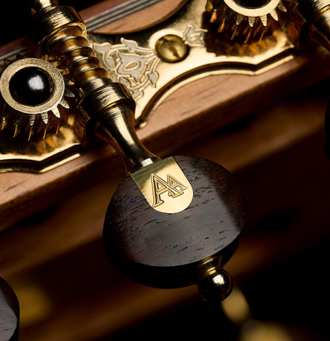 The tuning machine button of a 2025 Ariel Ameijenda "70th Anniversary" classical guitar made of Alerce and CSA rosewood