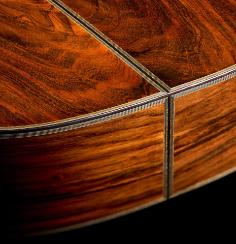 The back and sides at the foot of a 2026 Ariel Ameijenda "70th Anniversary" classical guitar made of alerce and CSA rosewood