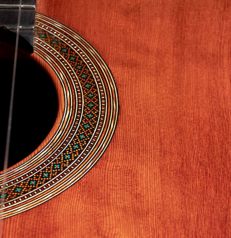 This is a close-up shot of the rosette of a 2022 Ariel Ameijenda "Confessional" AL/BL classical guitar