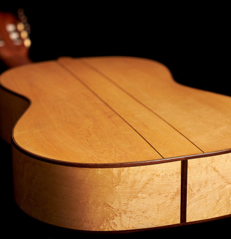 The back and sides at the foot of a 2023 Ariel Ameijenda "1885 Torres - SE 51" classical guitar made of spruce and maple