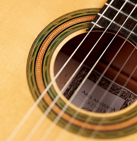 The soundboard and rosette of a 2023 Ariel Ameijenda "1885 Torres - SE 51" classical guitar made of spruce and maple