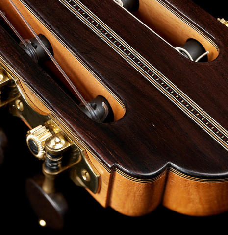 The headstock veneern and tuning machines of a 2024 Ariel Ameijenda classical guitar made of cedar and CSA rosewood