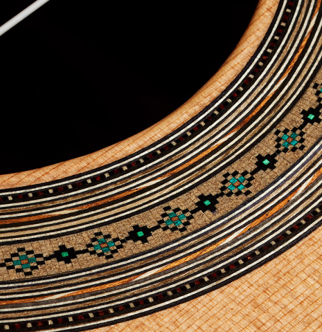 Detailed close-up of the rosette of a 2024 Ariel Ameijenda classical guitar made of cedar and CSA rosewood