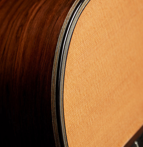 The soundboard, binding and purfling of a 2024 Ariel Ameijenda classical guitar made of cedar and CSA rosewood