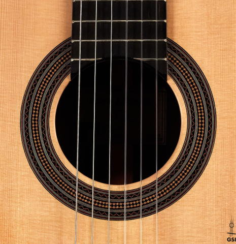 The rosette of a 2022 Mario Aracama classical guitar made of spruce and African rosewood