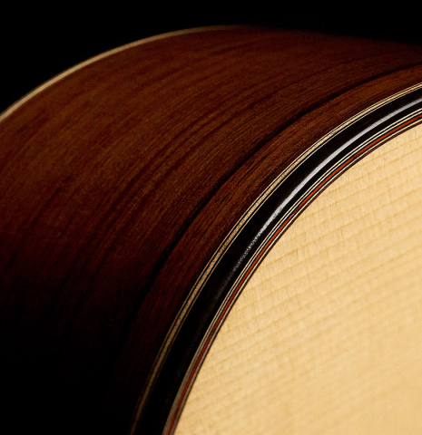The top binding and purfling of a 2026 Mario Aracama classical guitar made of spruce and African rosewood