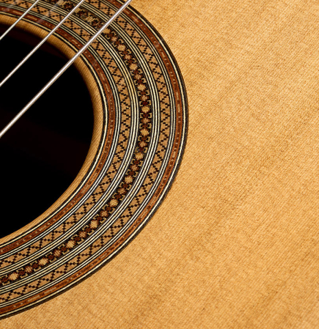 The soundboard and rosette of a 2025 Mario Aracama classical guitar made of cedar and cocobolo
