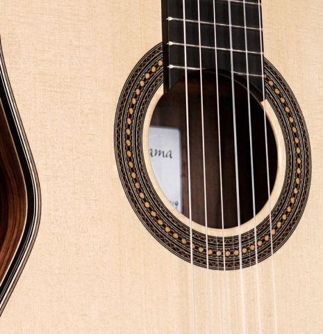 The top and rosette of a 2019 Mario Aracama classical guitar made of spruce and exotic Kamagong