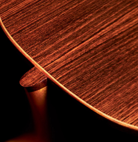 The heel and back binding of a 2019 Kevin Aram "Emily" classical guitar made of spruce and Indian rosewood