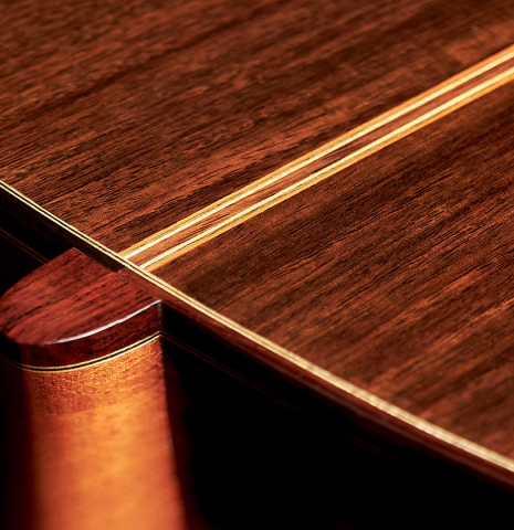 The heel of a 1999 Kevin Aram "Marina" classical guitar made with spruce and Indian rosewood.