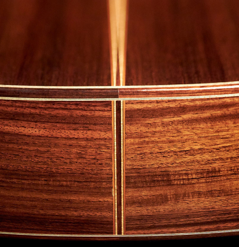 The side of a 1999 Kevin Aram "Marina" classical guitar made with spruce and Indian rosewood.