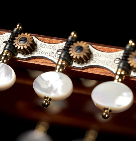 The machine heads of a 1999 Kevin Aram "Marina" classical guitar made with spruce and Indian rosewood.