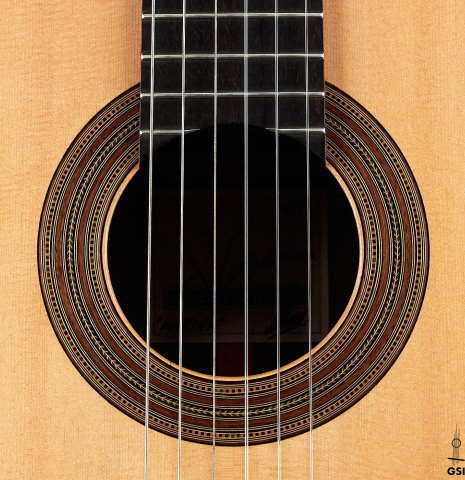 The rosette of a 1999 Kevin Aram "Marina" classical guitar made with spruce and Indian rosewood.