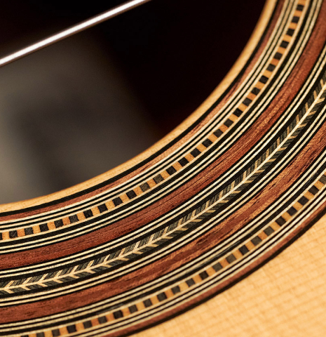 The rosette of a 1999 Kevin Aram "Marina" classical guitar made with spruce and Indian rosewood.