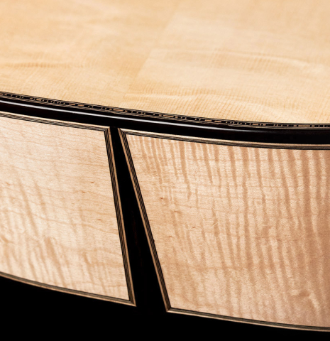 The back and sides at the foot of a 2023 Mario Aracama classical guitar made of spruce and maple.