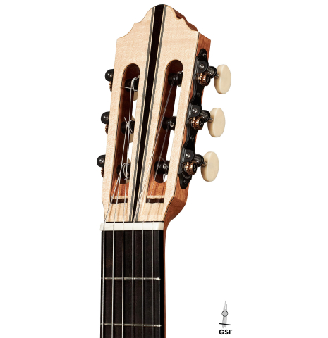 The headstock of a 2023 Mario Aracama classical guitar made of spruce and maple.