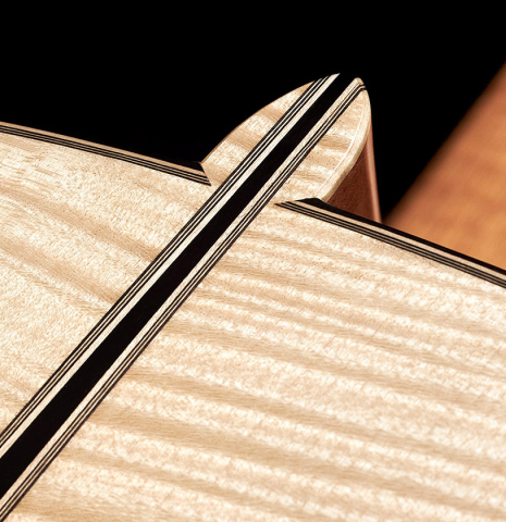 Closeup of the back and heel of a 2023 Mario Aracama classical guitar made of spruce and maple.