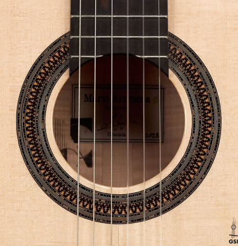 The rosette of a 2023 Mario Aracama classical guitar made of spruce and maple.