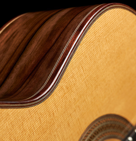 The soundboard and side of a 2024 Mario Aracama classical guitar made of cedar and Kamagong
