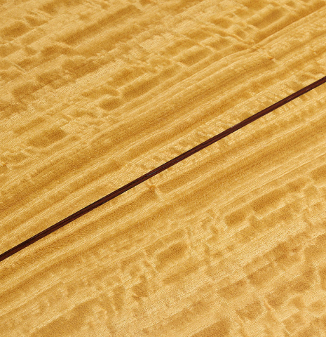 The back center seam of a 2021 Kevin Aram "Nancy" classical guitar made of spruce and satinwood