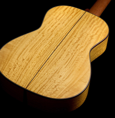 The back and sides of a 2021 Kevin Aram "Nancy" classical guitar made of spruce and satinwood