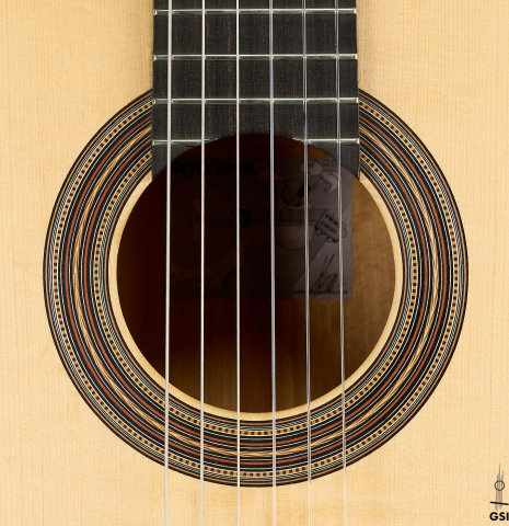 The rosette of a 2021 Kevin Aram "Nancy" classical guitar made of spruce and satinwood