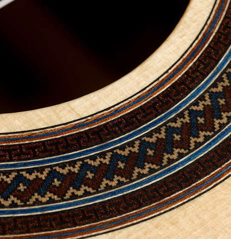 Detailed closeup of the rosette of a 2025 Manuel Arango classical guitar made of spruce and Indian rosewood