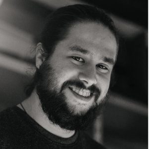 Black-and-white portrait of Swiss guitar maker Manuel Arango, smiling