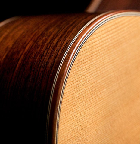 The side and binding of a 2022 Asturias &quot;Double Top&quot; classical guitar made of cedar and Indian rosewood
