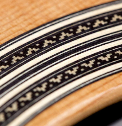 A close-up of the rosette of an Asturias &quot;Double Top&quot; classical guitar made of cedar and Indian rosewood