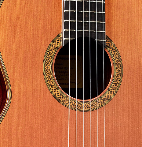 The soundboard and rosette of a 2014 Angel Benito Aguado classical guitar made of cedar and Indian rosewood.