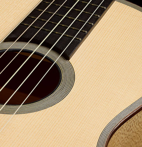 The fingerboard, top and rosette of a 2011 Angel Benito Aguado "Romantic" classical guitar made of spruce and maple